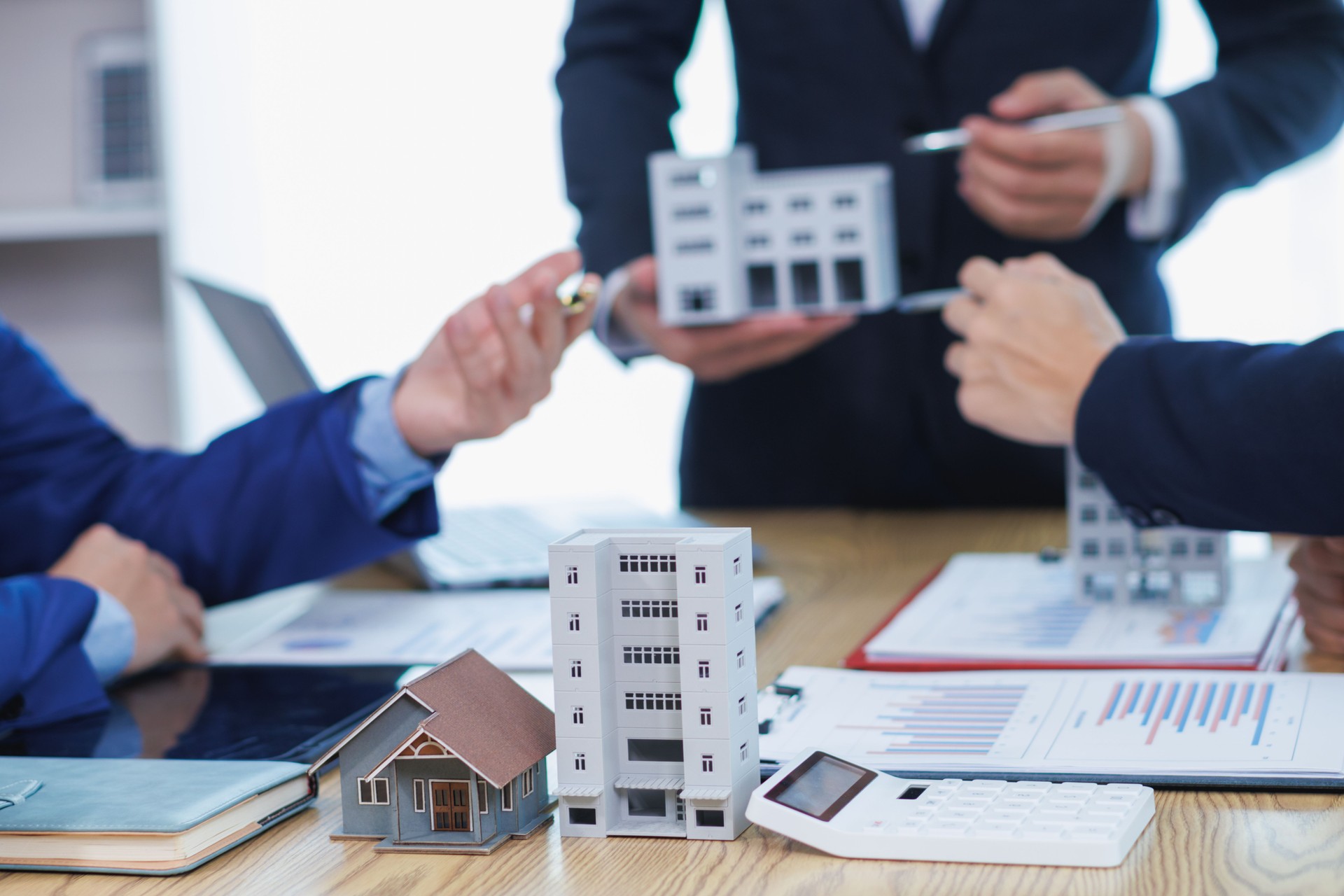 group of businessmen and investors discuss investing in real estate and jointly plan investments in construction projects of condominiums and apartments for sale and rent. investment advisory concept